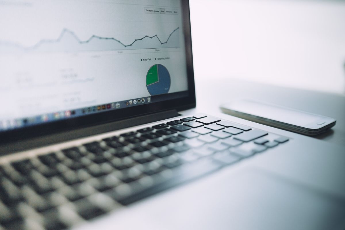 A laptop showing analytics alongside planning notes